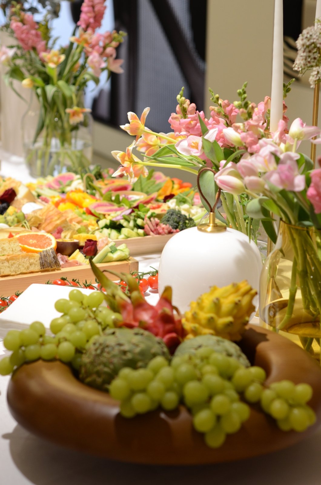 Decorative fruit arrangement with flowers on a table